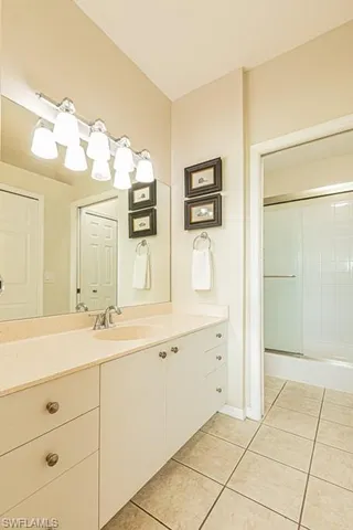 a bathroom with a sink a mirror and a shower