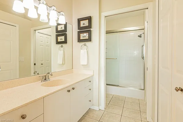 a bathroom with a shower sink and mirror