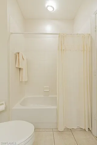 a bathroom with a toilet and shower
