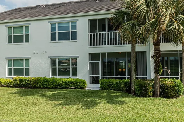 a view of a house with a yard and plants