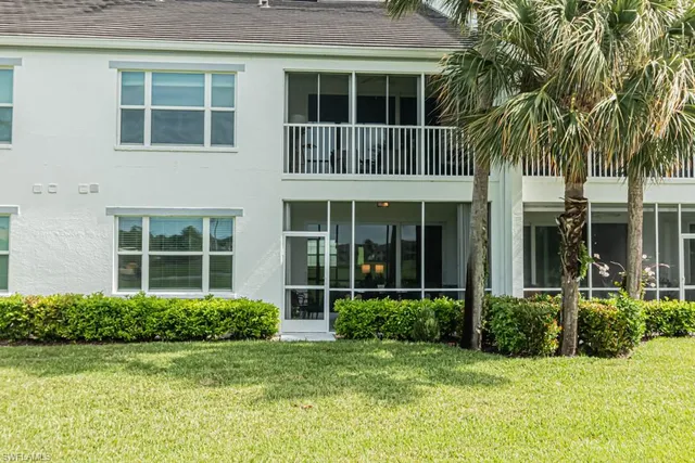 front view of a brick house with a yard