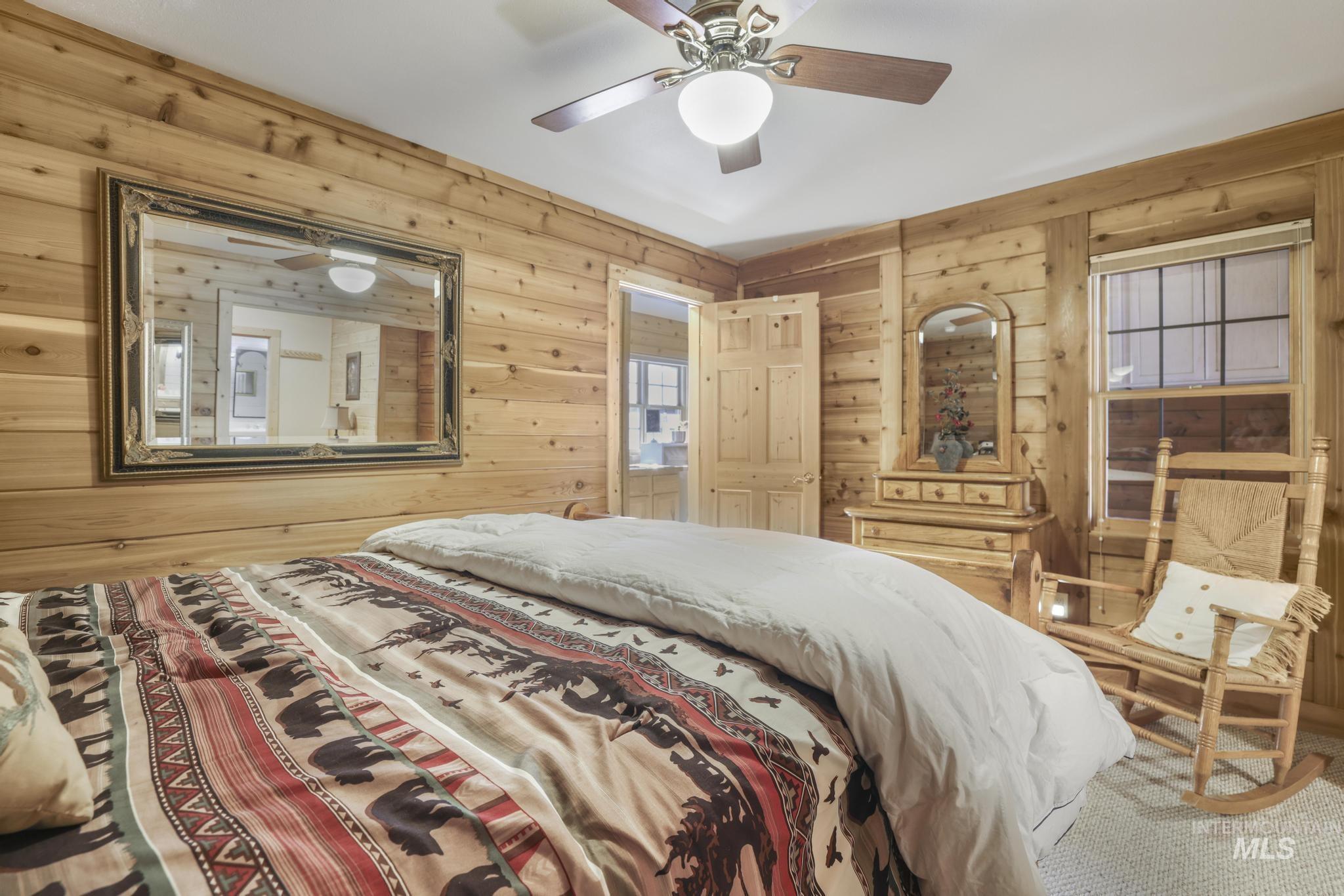 203 North Brush Road Fairfield, ID 83327 - Photo 18 of 50 Bedroom with wood walls and a ceiling fan