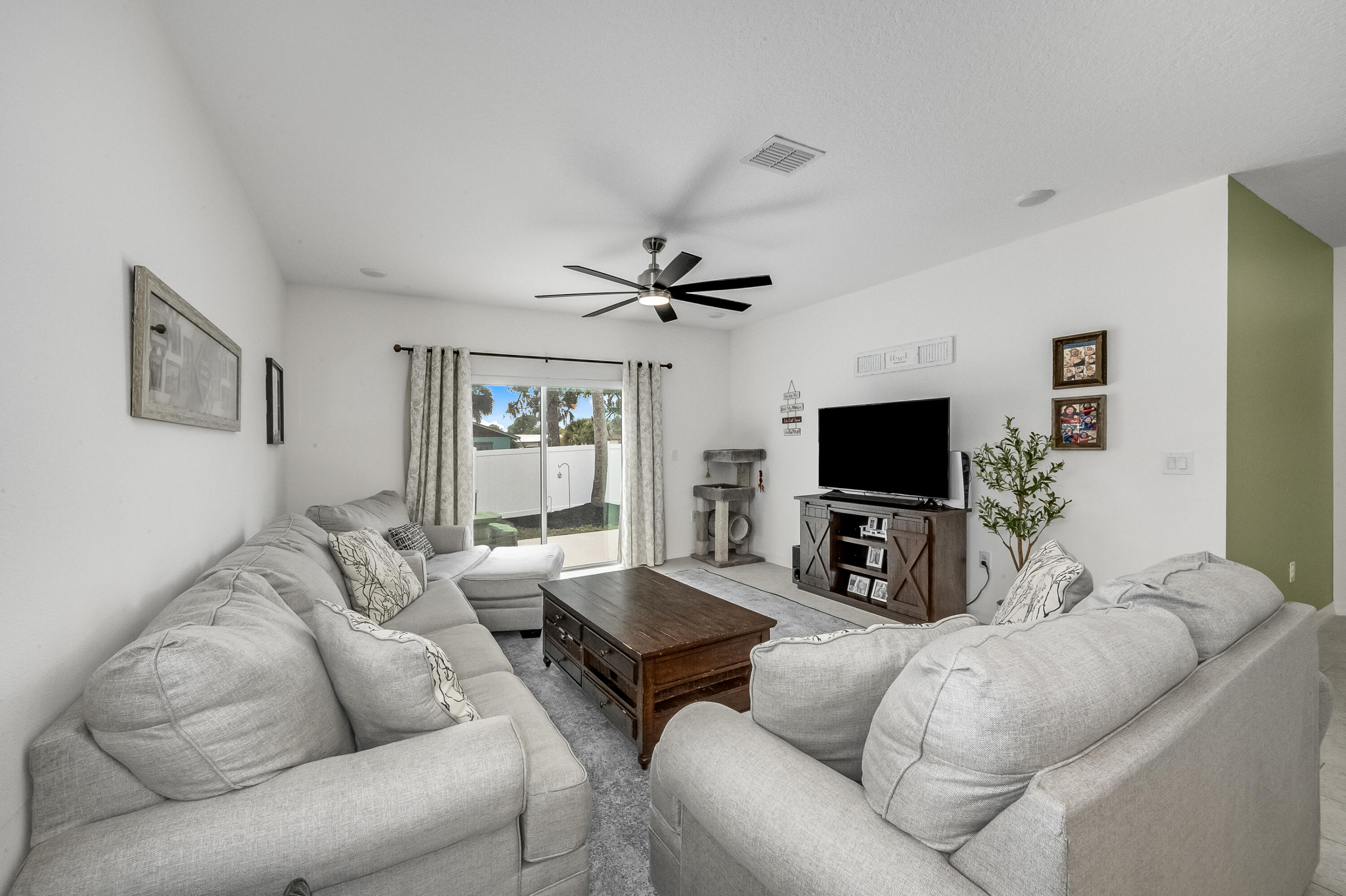953 Edensor Lane Rockledge, FL 32955 - Photo 14 of 39 a living room with furniture and a flat screen tv