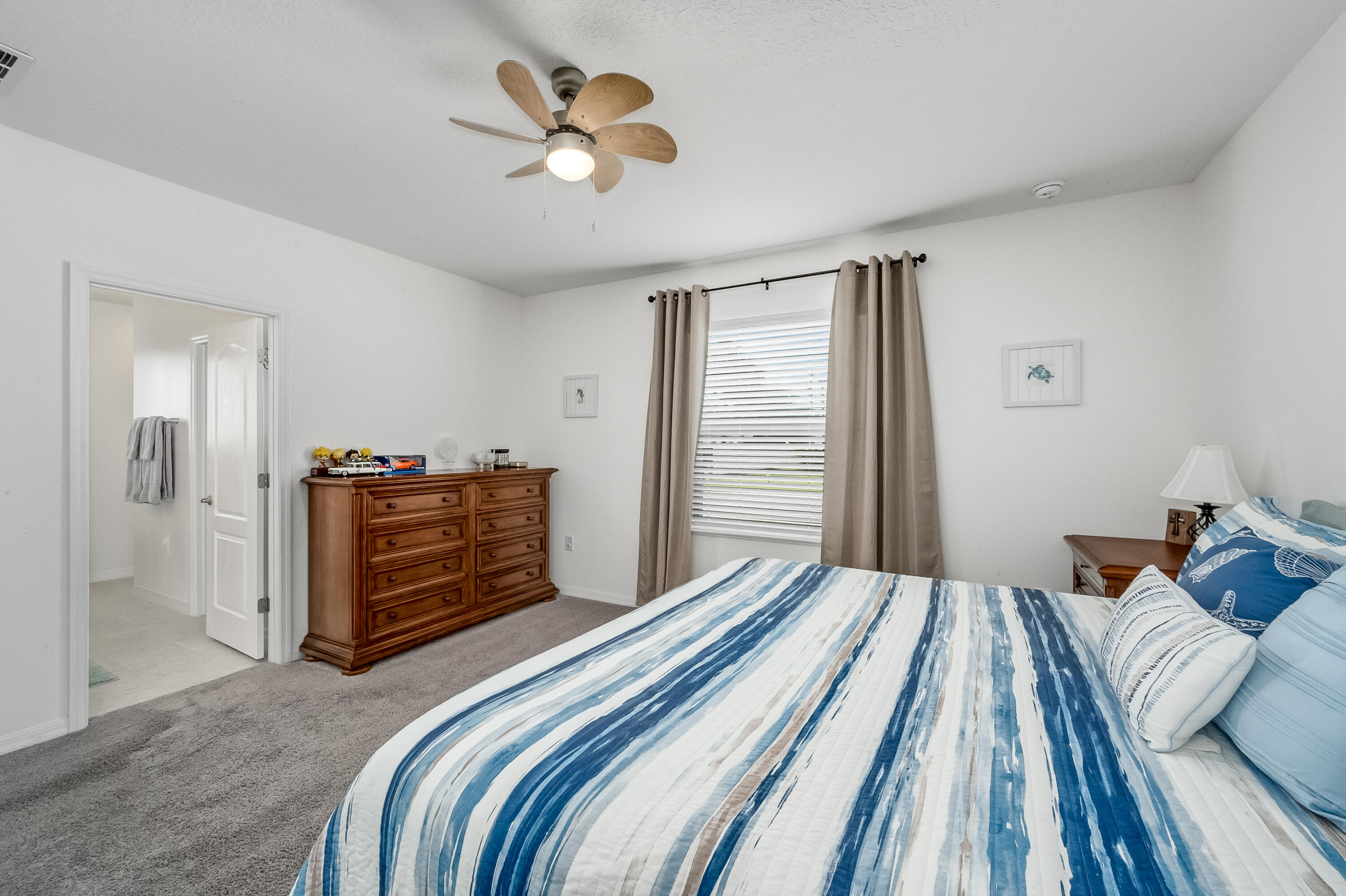 953 Edensor Lane Rockledge, FL 32955 - Photo 16 of 39 a bedroom with a bed and a chandelier