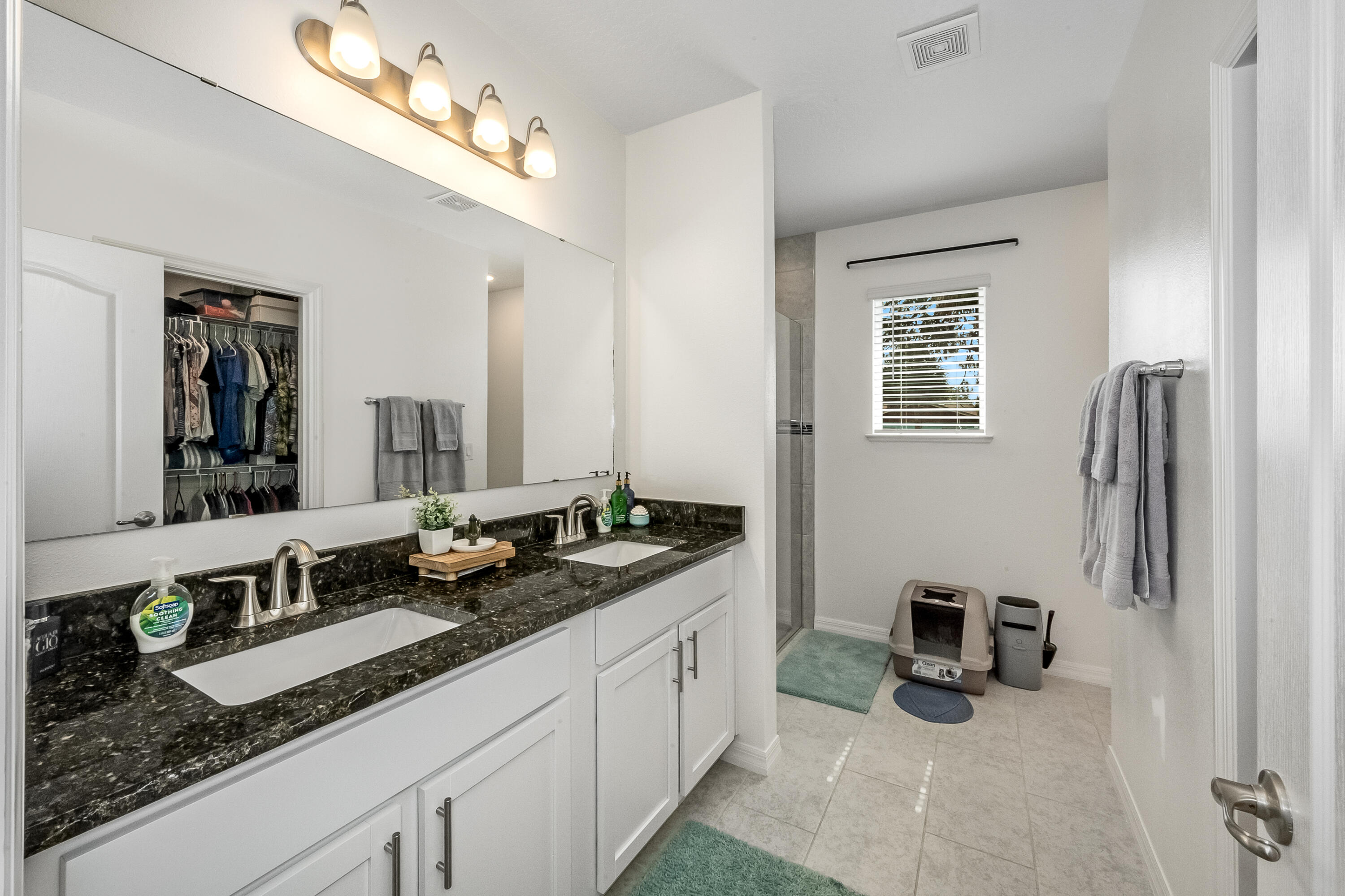 953 Edensor Lane Rockledge, FL 32955 - Photo 17 of 39 a spacious en suite bathroom with double sink and a mirror