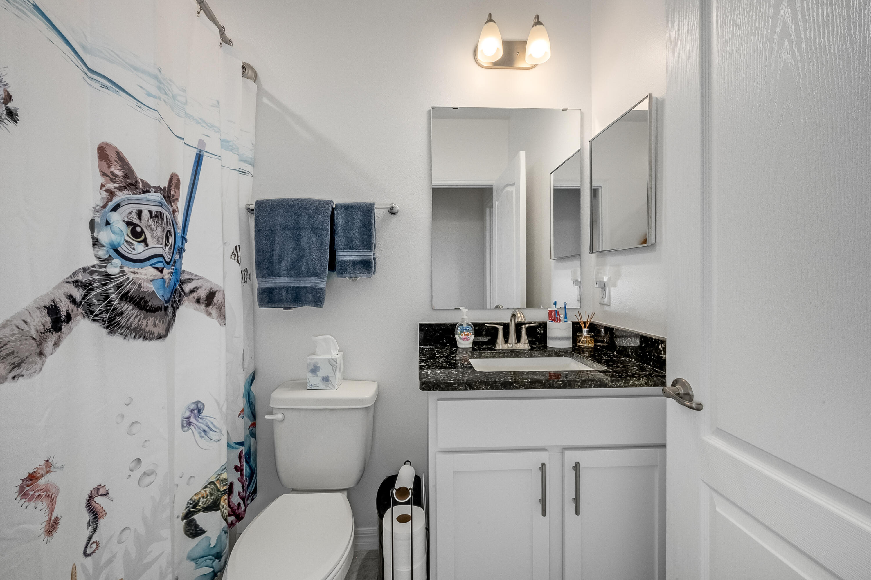 953 Edensor Lane Rockledge, FL 32955 - Photo 22 of 39 a bathroom with a granite countertop toilet sink and mirror