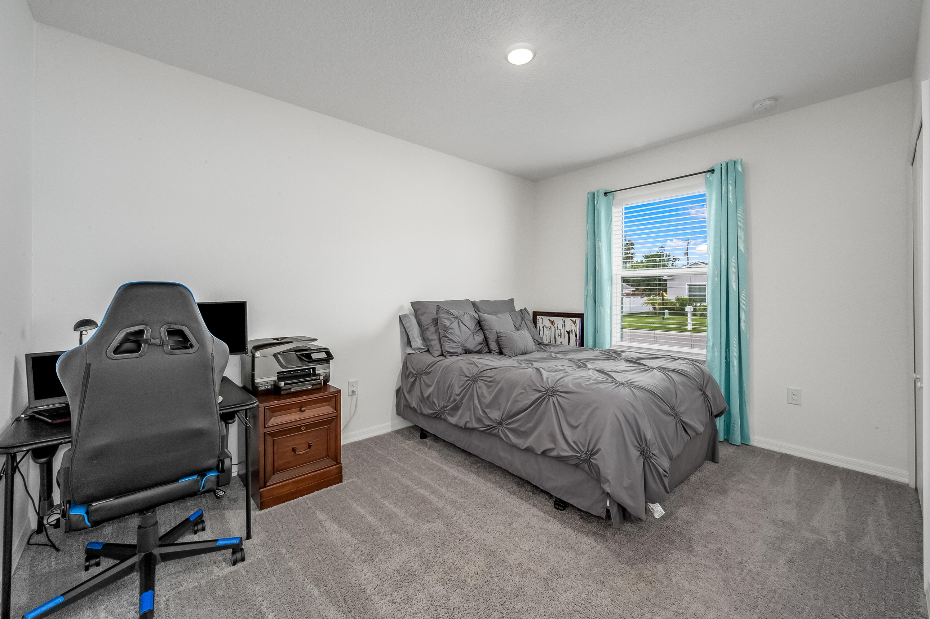 953 Edensor Lane Rockledge, FL 32955 - Photo 24 of 39 a bedroom with a bed and a chair