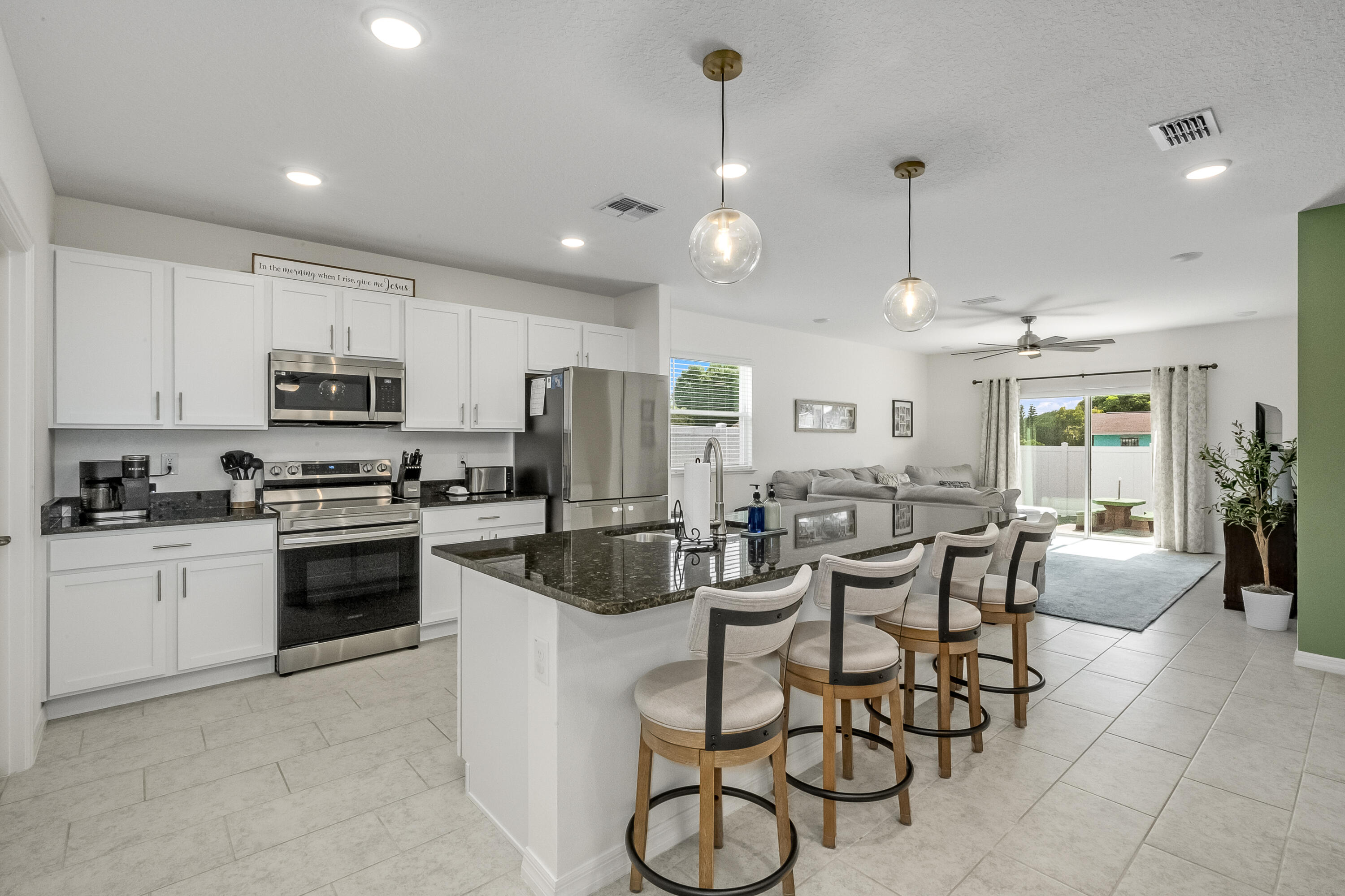 953 Edensor Lane Rockledge, FL 32955 - Photo 8 of 39 a kitchen with stainless steel appliances a stove a sink a oven a dining table and chairs
