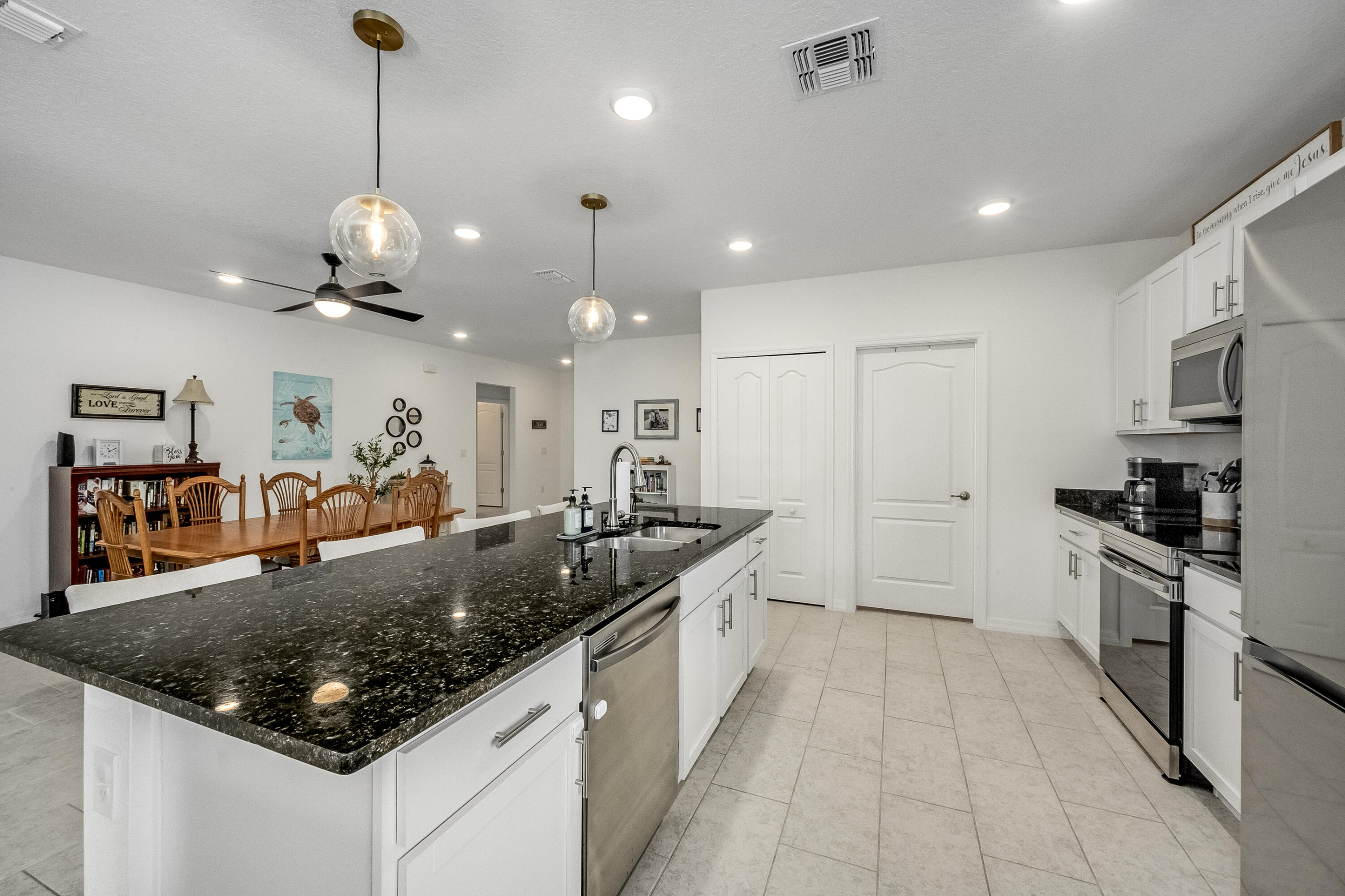 953 Edensor Lane Rockledge, FL 32955 - Photo 9 of 39 a large kitchen with stainless steel appliances granite countertop a sink and a refrigerator