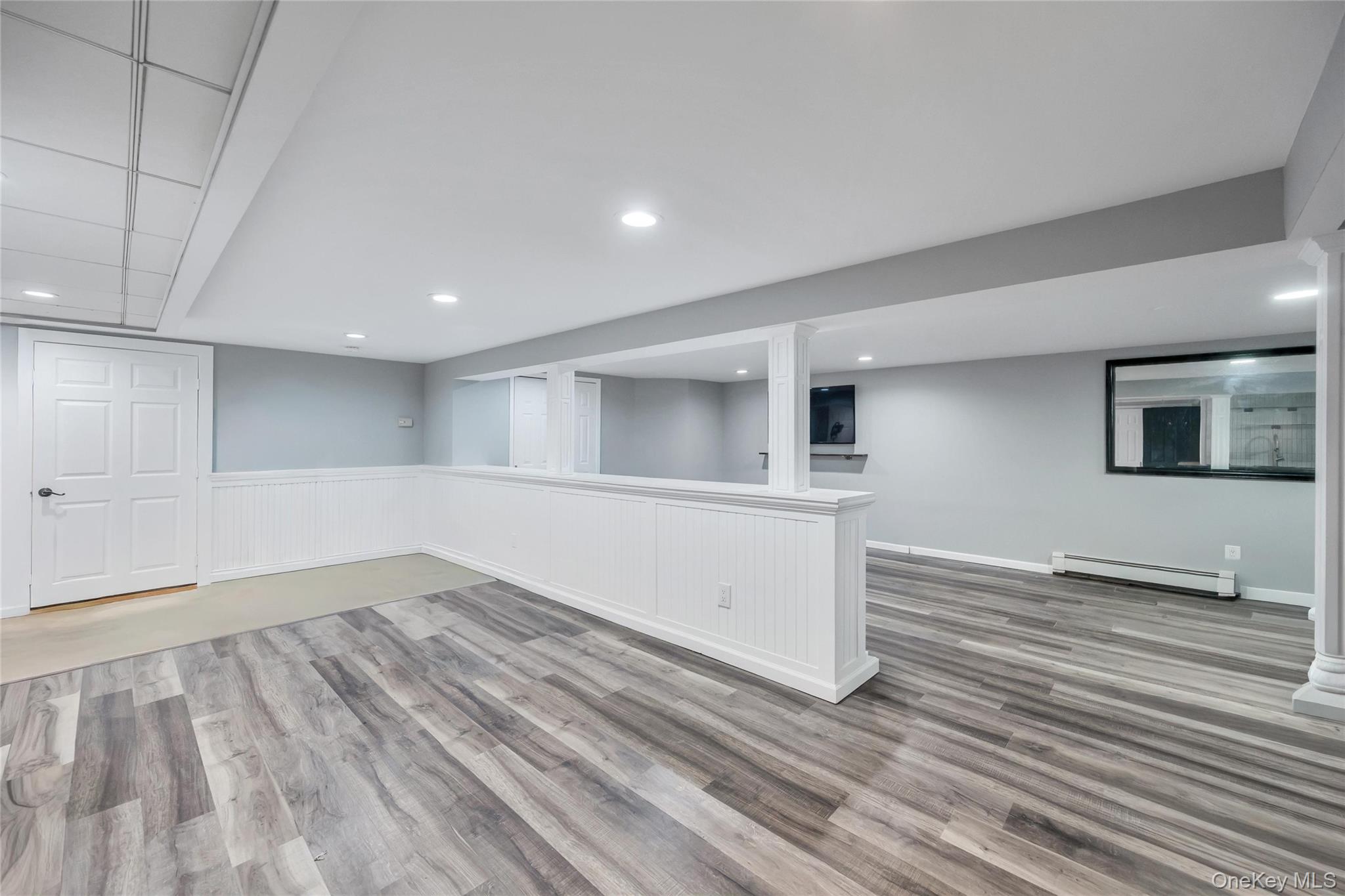 19 Joan Road Bay Shore, NY 11706 - Photo 39 of 50 Spacious lower level featuring wood-finish flooring, recessed lighting, and a built-in wet bar with a beverage refrigerator