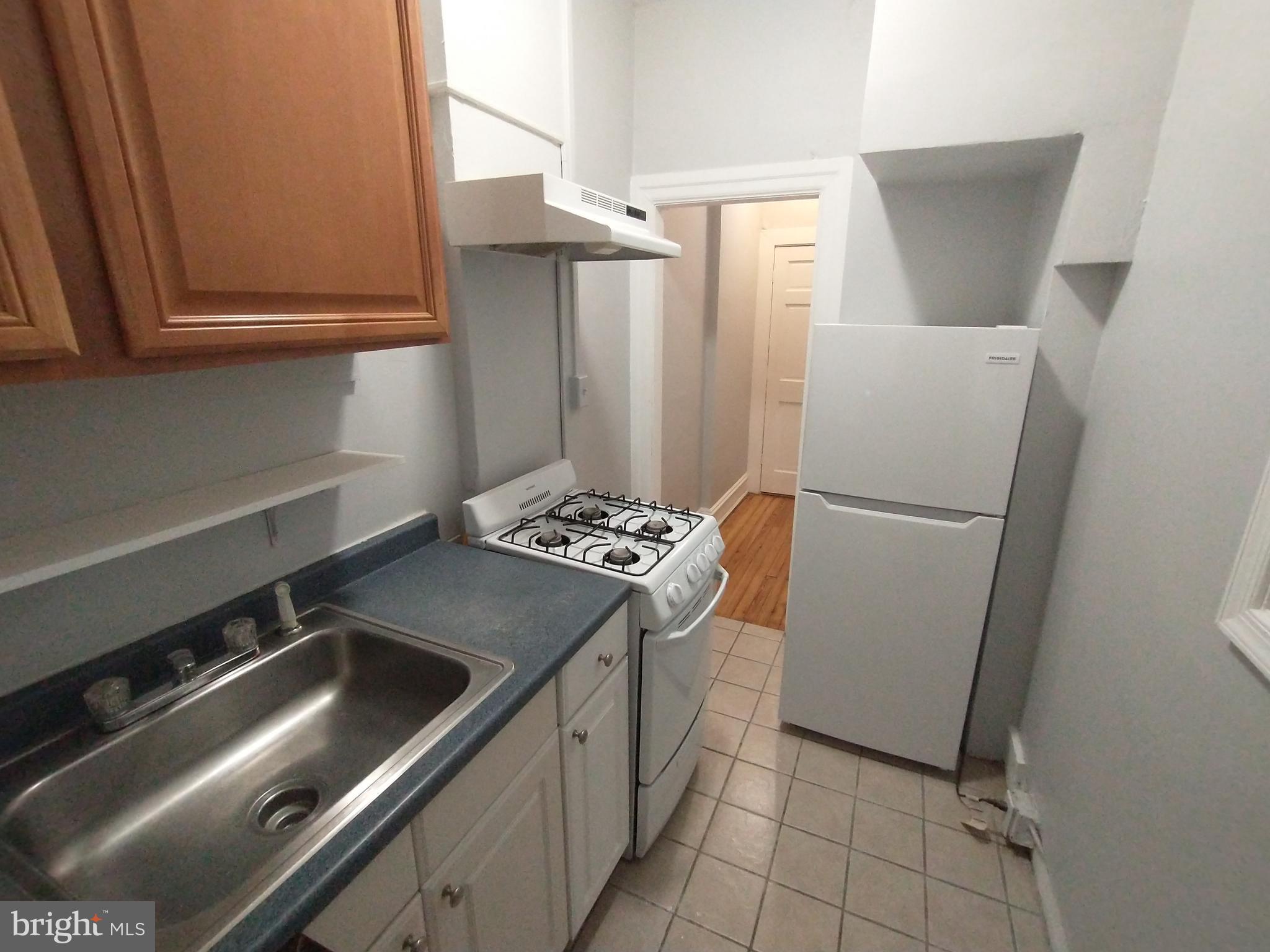 307 Dolphin Street, Unit 2B Baltimore, MD 21201 - Photo 1 of 17 a kitchen with stainless steel appliances granite countertop a refrigerator and a sink