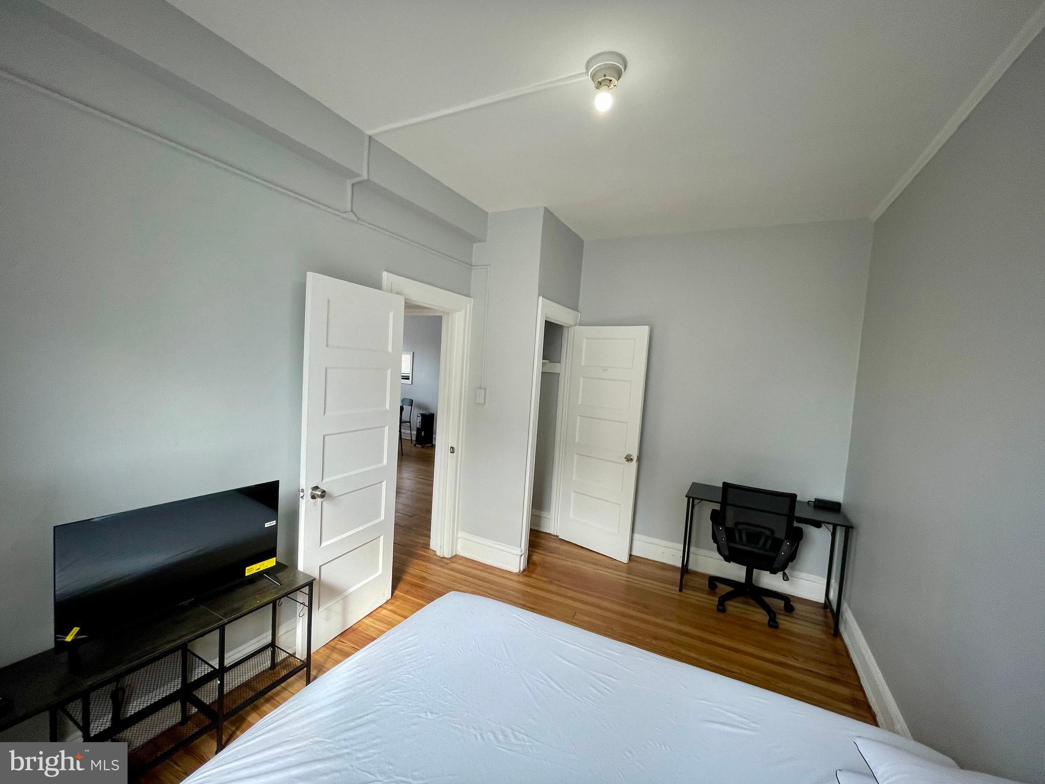 307 Dolphin Street, Unit 2B Baltimore, MD 21201 - Photo 12 of 17 a living room with furniture and a flat screen tv