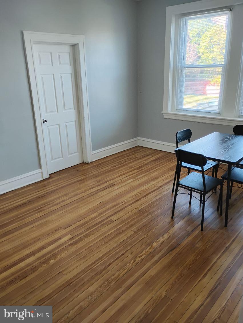 307 Dolphin Street, Unit 2B Baltimore, MD 21201 - Photo 4 of 17 a view of a room with wooden floor and a window