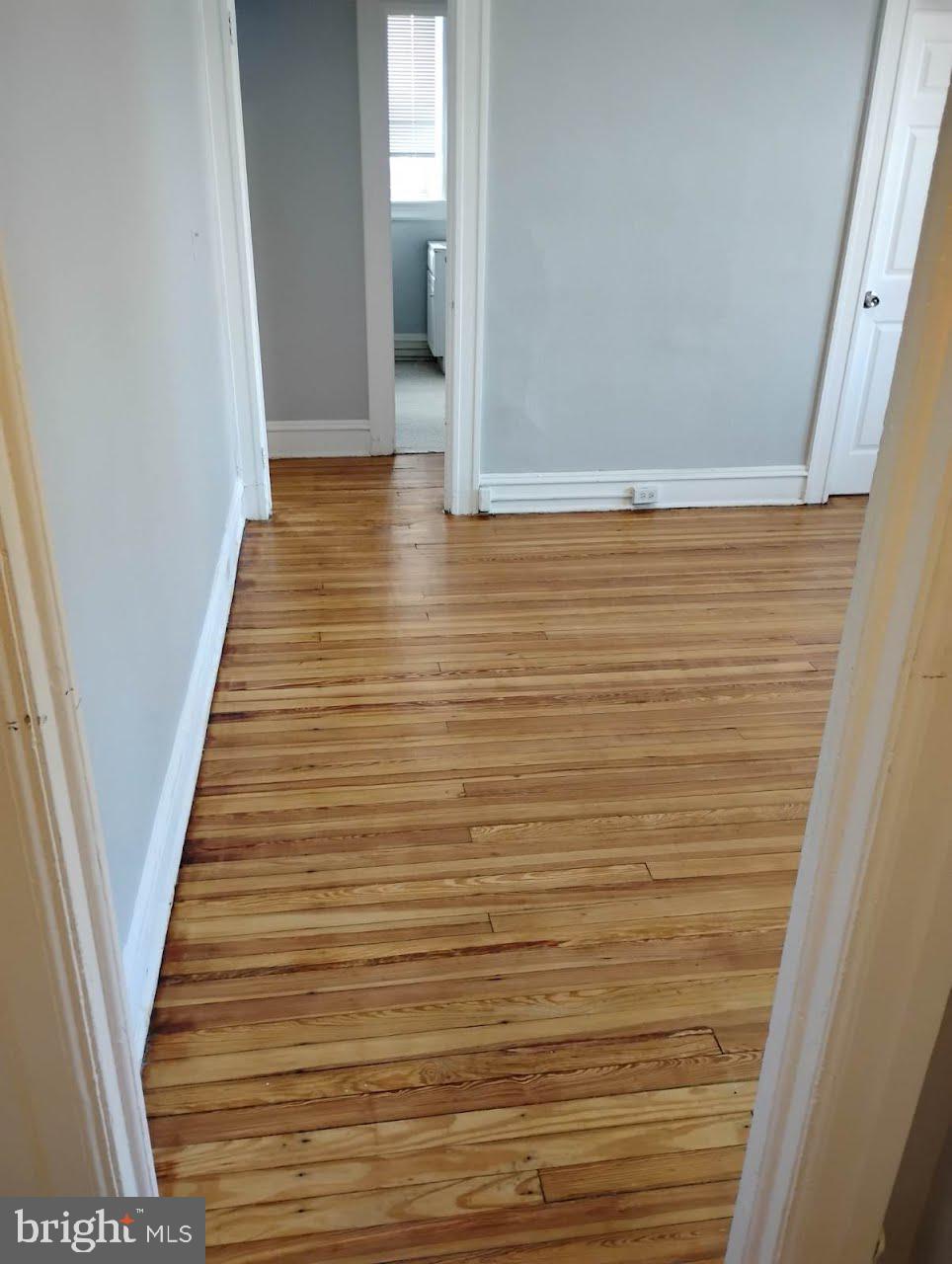 307 Dolphin Street, Unit 2B Baltimore, MD 21201 - Photo 5 of 17 a view of a hallway with wooden floor and staircase