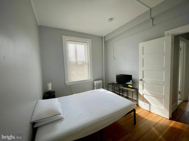 a bedroom with a bed and a tv