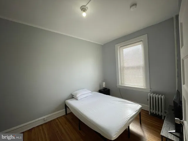 a view of a room with wooden floor and a window