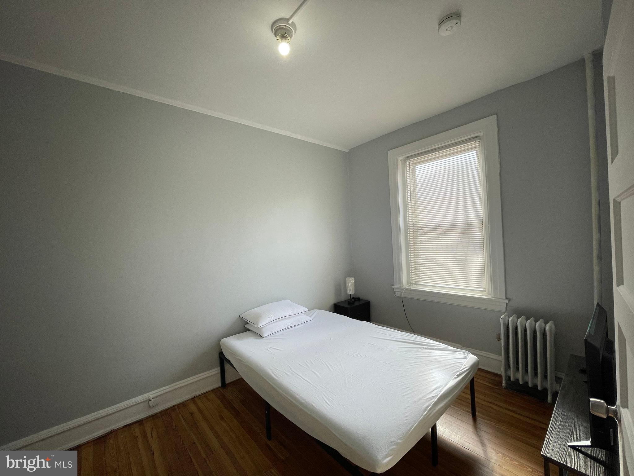 307 Dolphin Street, Unit 2B Baltimore, MD 21201 - Photo 9 of 17 a view of a room with wooden floor and a window