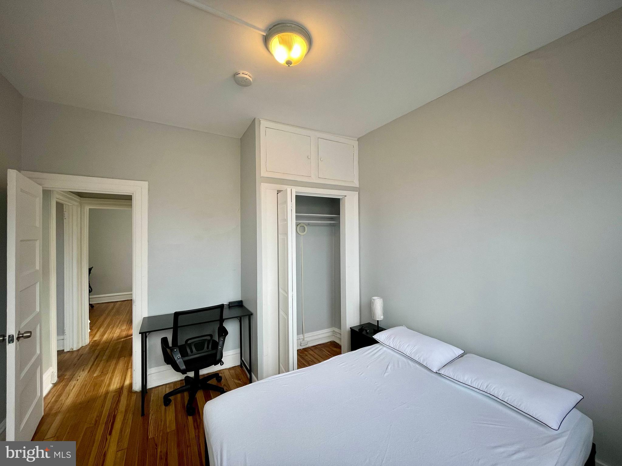 307 Dolphin Street, Unit 2B Baltimore, MD 21201 - Photo 10 of 17 a bedroom with a bed and a table