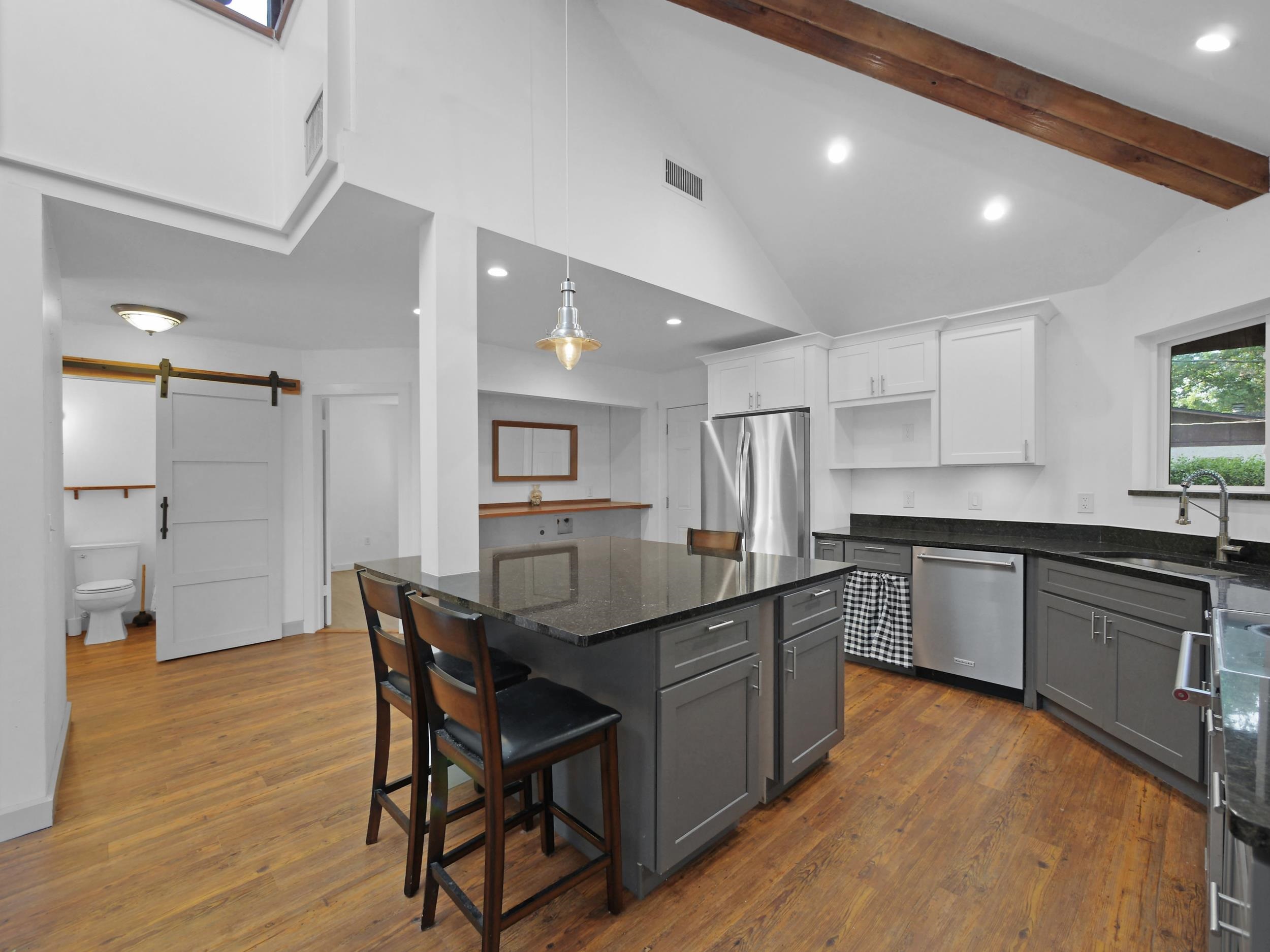 369 Orchis Road St. Augustine, FL 32086 - Photo 14 of 41 a kitchen with stainless steel appliances granite countertop wooden floor a dining table chairs and sink