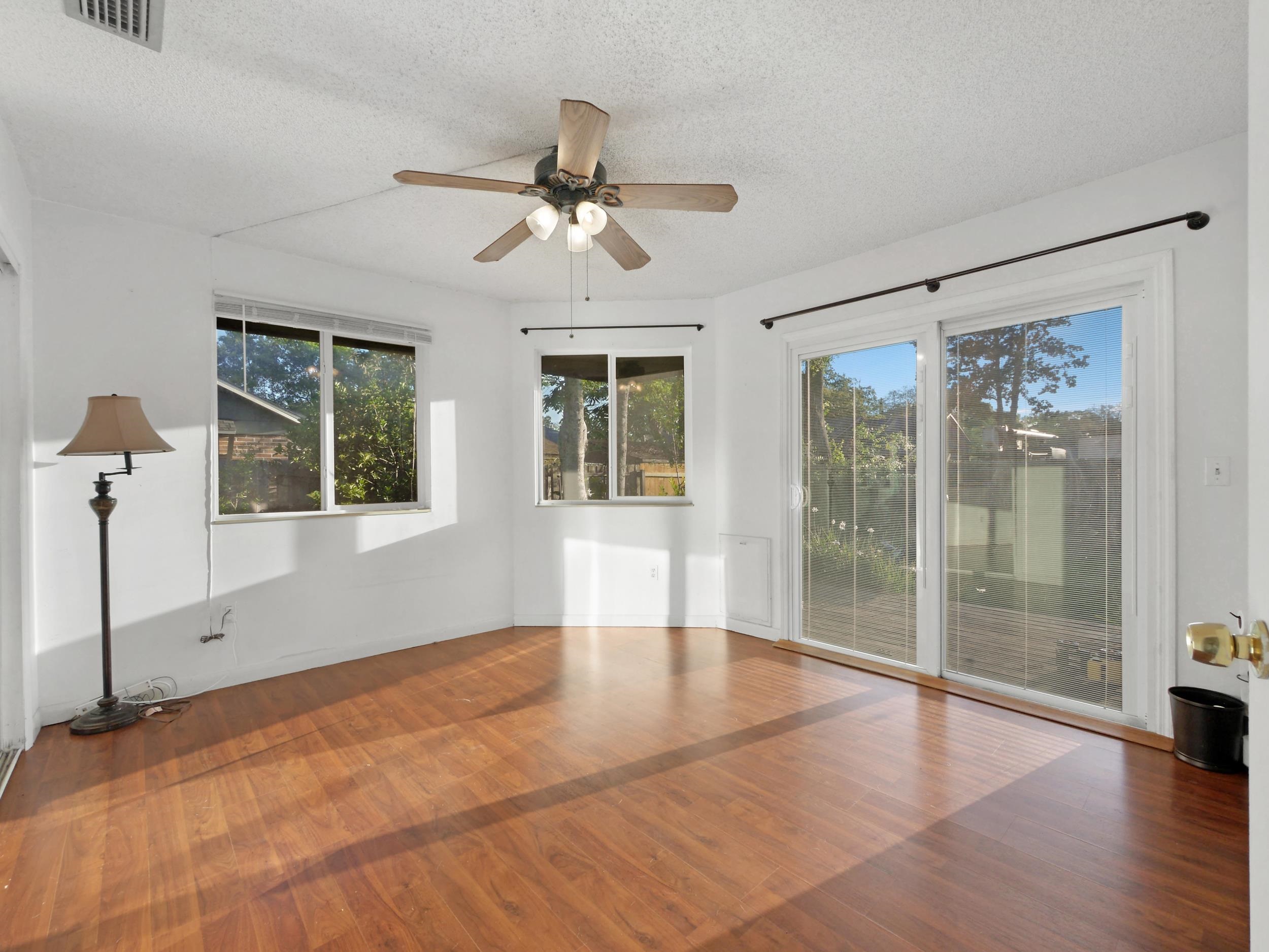369 Orchis Road St. Augustine, FL 32086 - Photo 18 of 41 a view of an empty room with window and wooden floor