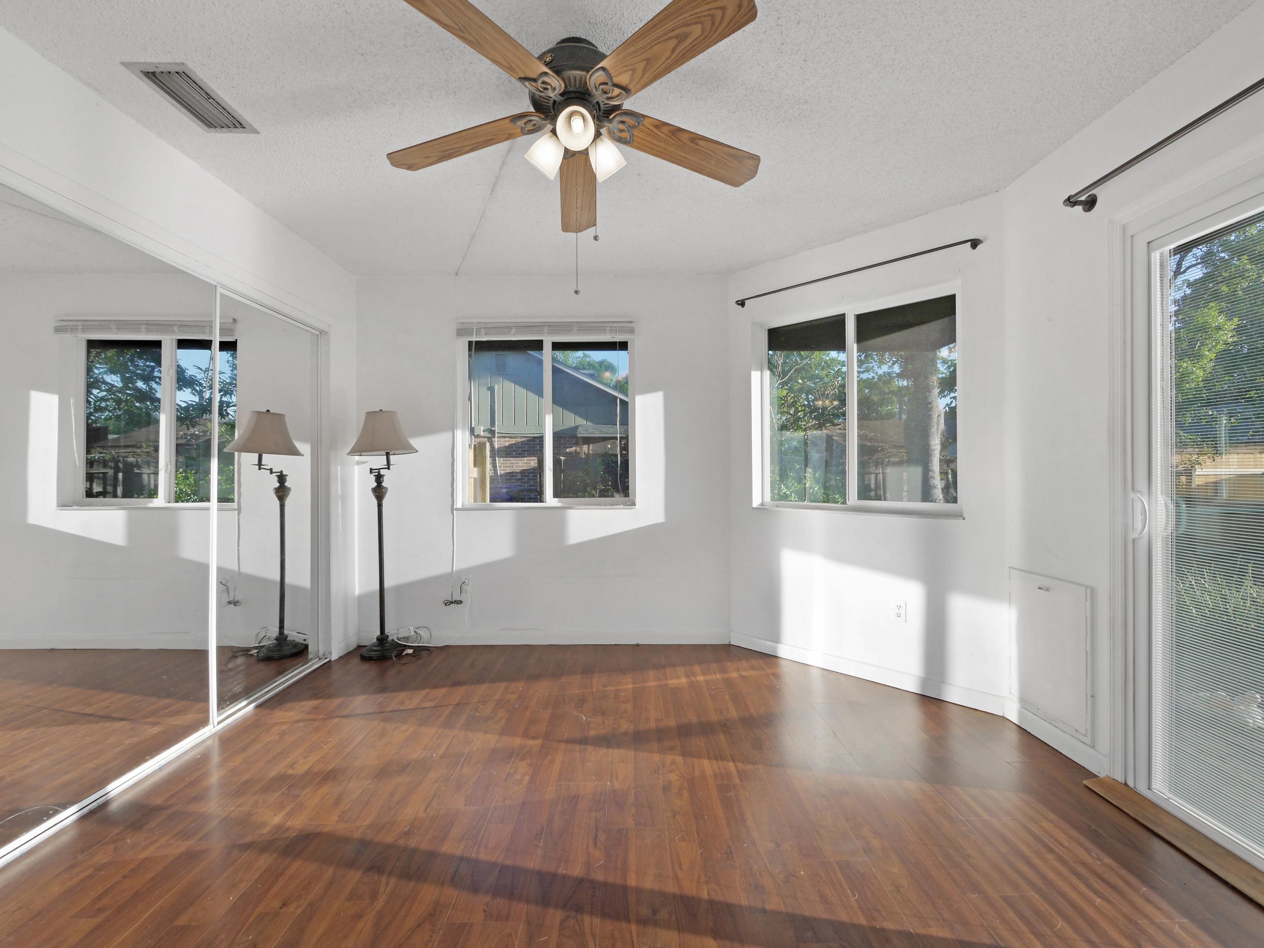 369 Orchis Road St. Augustine, FL 32086 - Photo 19 of 41 a view of empty room with wooden floor and fan