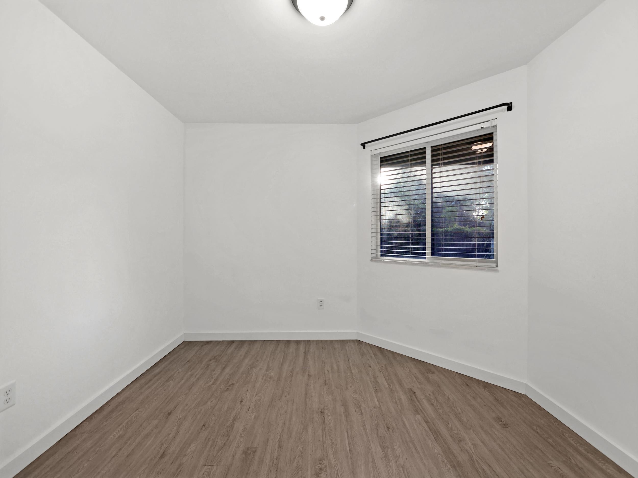 369 Orchis Road St. Augustine, FL 32086 - Photo 23 of 41 a view of an empty room with wooden floor and a window