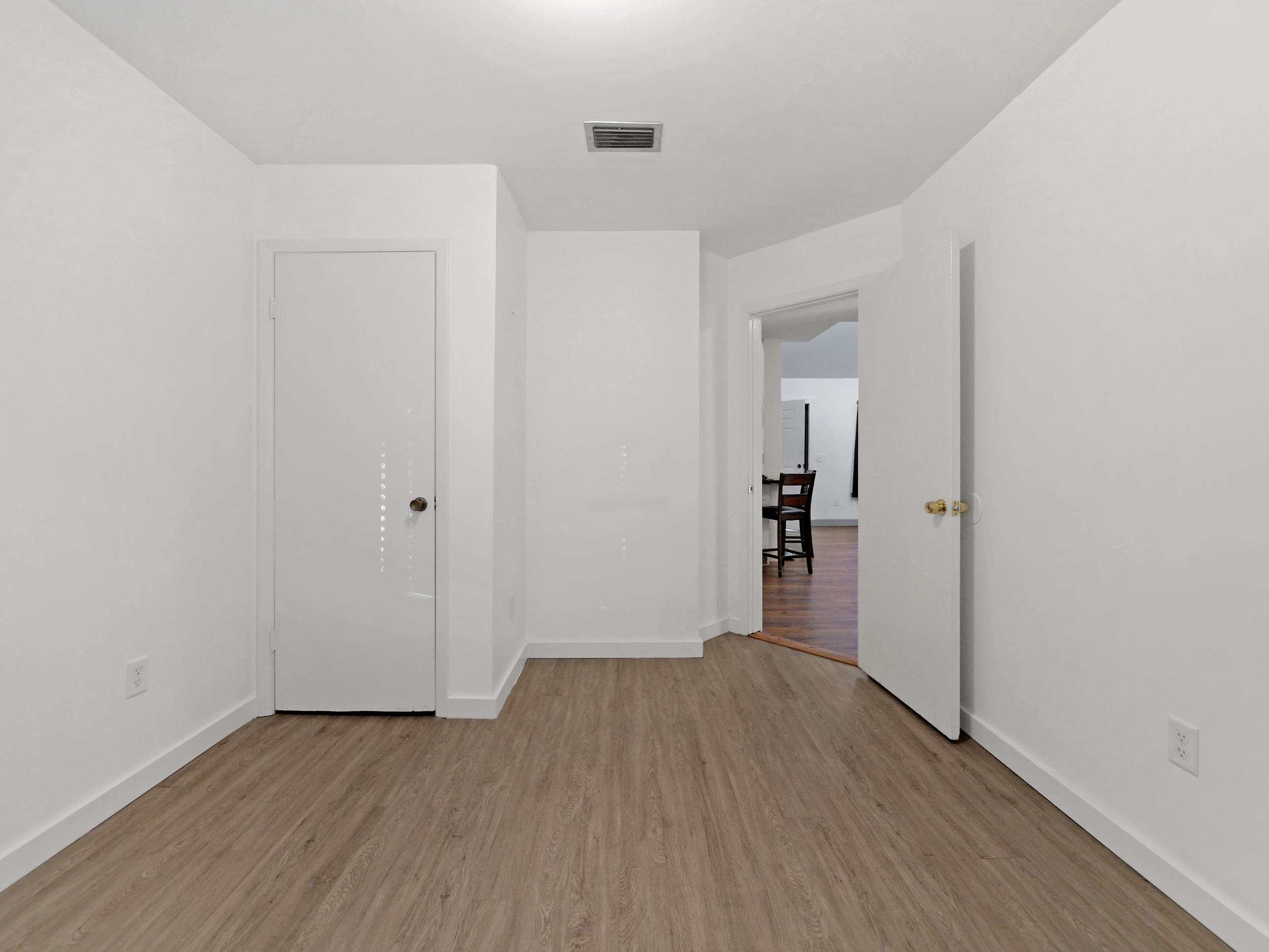 369 Orchis Road St. Augustine, FL 32086 - Photo 24 of 41 a view of a hallway with wooden floor and a bathroom