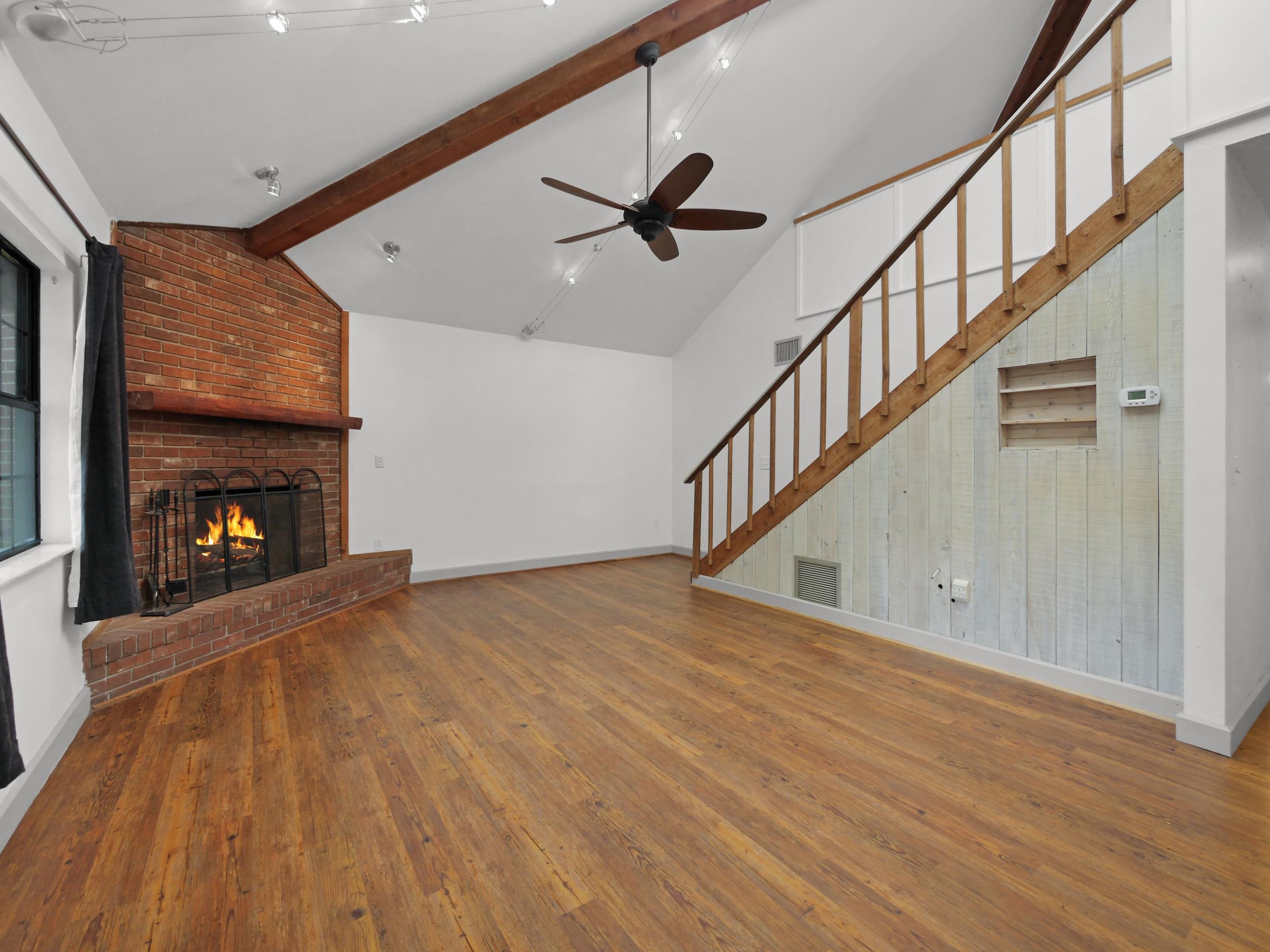 369 Orchis Road St. Augustine, FL 32086 - Photo 5 of 41 a view of an empty room and wooden floor a fire place