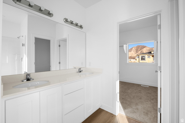 1510 West 600 North, Unit 4A Mapleton, UT 84664 - Photo 13 of 23 Bathroom featuring double vanity, a shower, dark wood-style flooring, and dark colored carpet