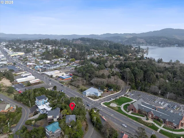 an aerial view of residential house with outdoor space and trees