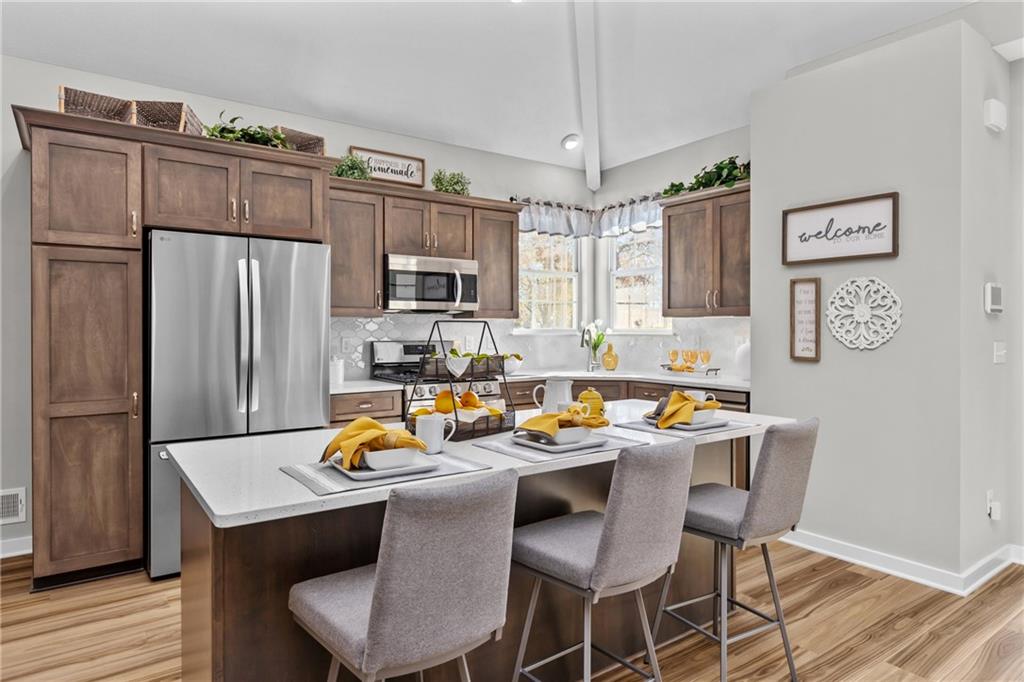 106 Independence Drive Cabot, PA 16023 - Photo 14 of 32 a kitchen with stainless steel appliances granite countertop a dining table chairs refrigerator and microwave