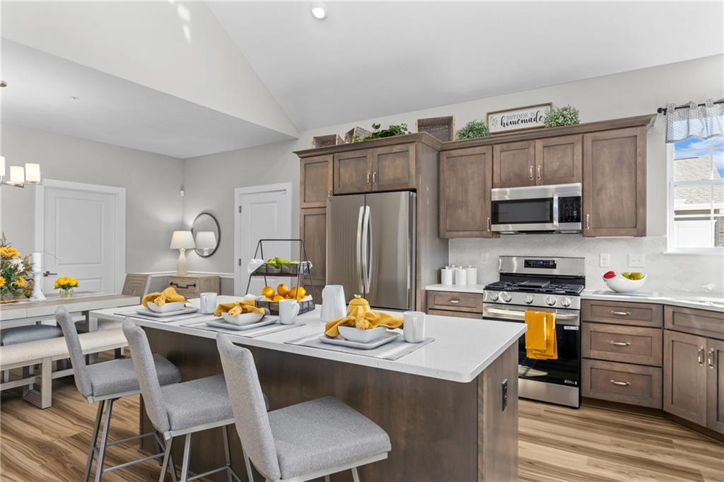 106 Independence Drive Cabot, PA 16023 - Photo 17 of 32 a kitchen with a dining table and chairs