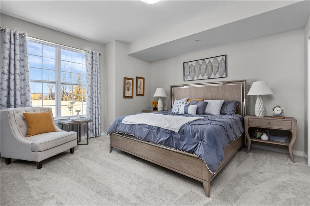 106 Independence Drive Cabot, PA 16023 - Photo 23 of 32 a spacious bedroom with a bed and a couch