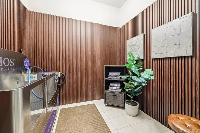 a dining room with furniture and a potted plant
