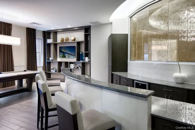 a kitchen with stainless steel appliances granite countertop a sink a stove and refrigerator