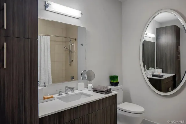 a bathroom with a toilet sink and mirror