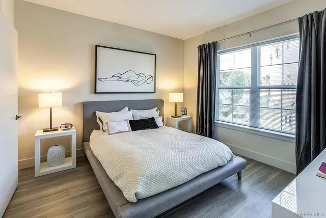 a bedroom with a large bed and a window