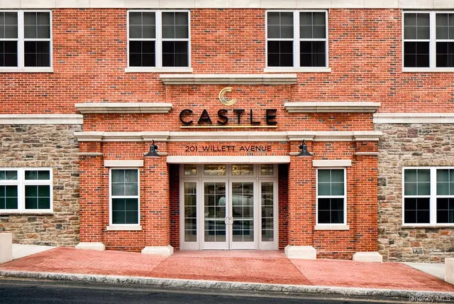 a front view of a building with many windows