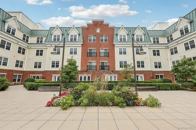 a front view of a residential apartment building with a yard