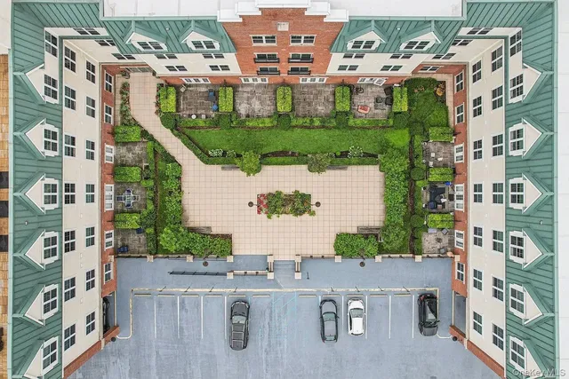 an aerial view of residential houses with outdoor space and parking
