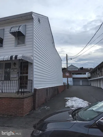 a roof deck with table and chairs