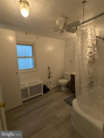 a bathroom with a toilet a sink and bathtub
