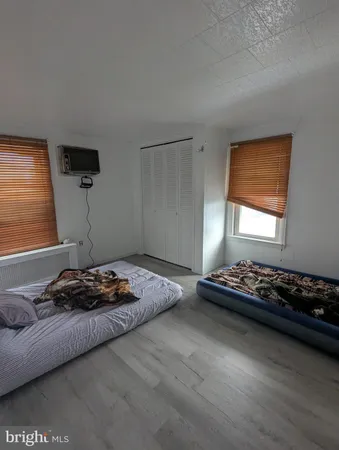 a bedroom with bed and a window