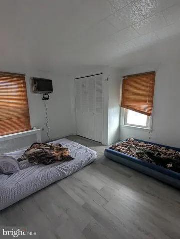 a bedroom with bed and a window