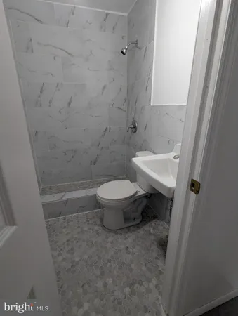 a white toilet sitting next to a sink