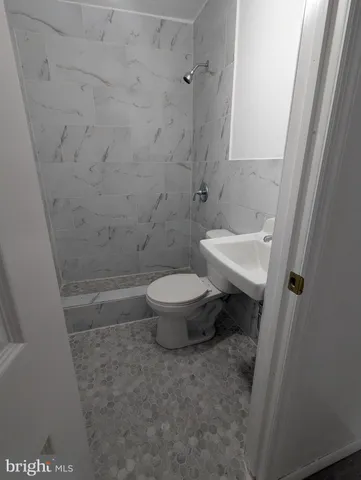 a white toilet sitting next to a sink