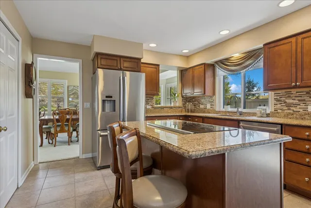 a kitchen with a refrigerator a sink and a cabinets