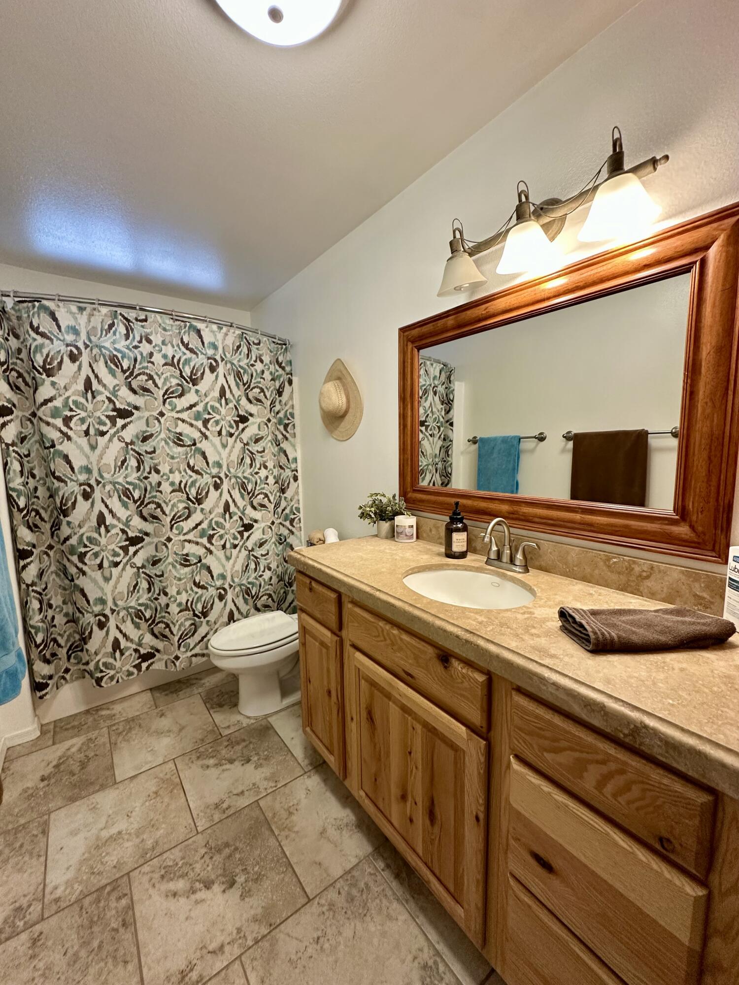 1731 Riviera Drive Blythe, CA 92225 - Photo 15 of 36 a bathroom with a granite countertop sink mirror vanity and toilet