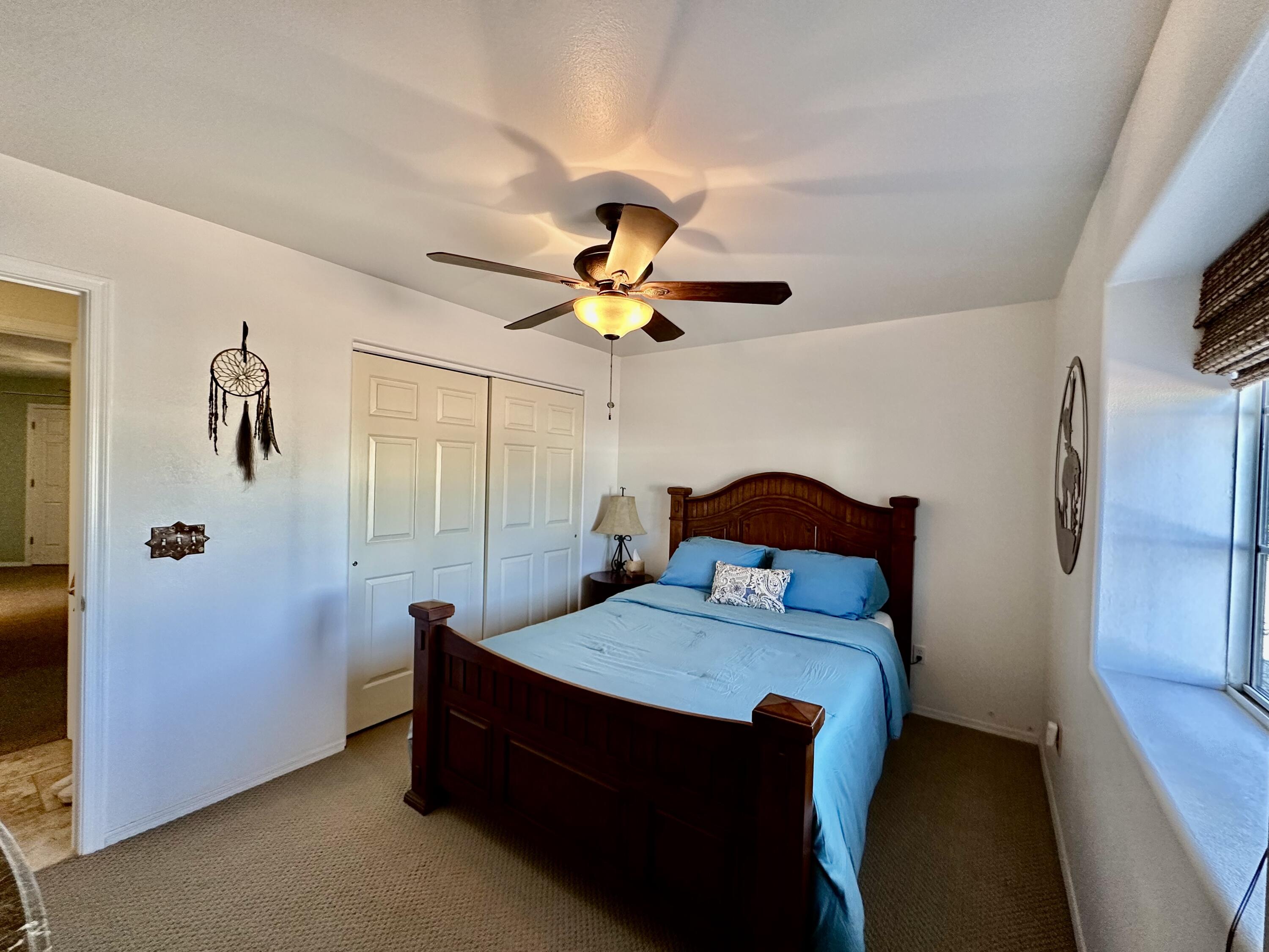 1731 Riviera Drive Blythe, CA 92225 - Photo 18 of 36 a bedroom with a bed and a chandelier