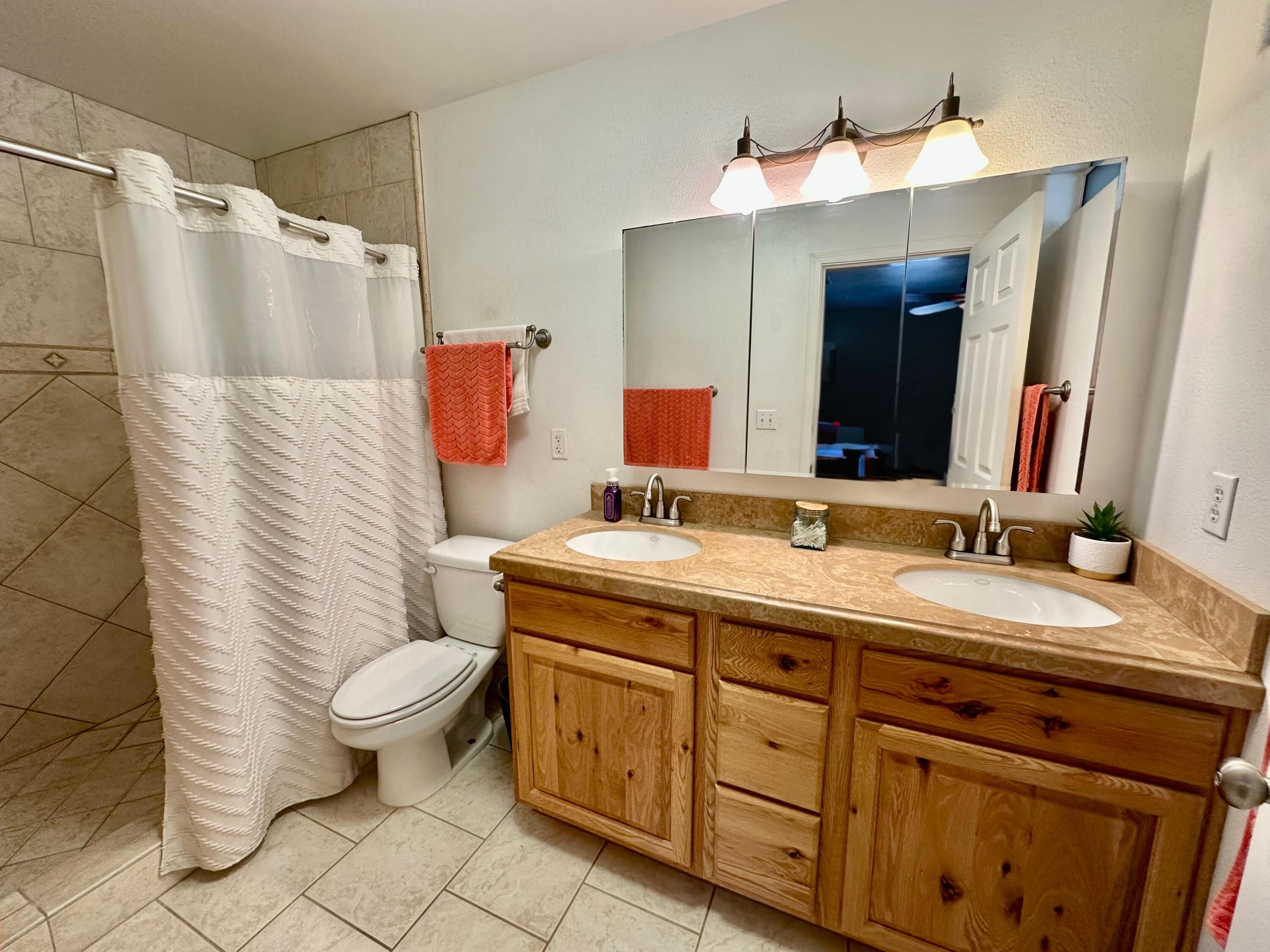 1731 Riviera Drive Blythe, CA 92225 - Photo 21 of 36 a bathroom with a granite countertop sink mirror vanity and toilet